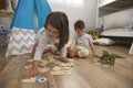 Two Children Playing Number Puzzle Game Together In Playroom