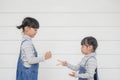 Two Children playing in a rock-paper-scissors game on white background Royalty Free Stock Photo