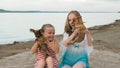 Two children playing which dogs on the sand on the beach. Royalty Free Stock Photo