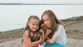 Two children playing which dogs on the sand on the beach. Royalty Free Stock Photo