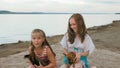 Two children playing which dogs on the sand on the beach. Royalty Free Stock Photo