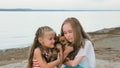 Two children playing which dogs on the sand on the beach. Royalty Free Stock Photo