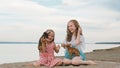 Two children playing which dogs on the sand on the beach. Royalty Free Stock Photo