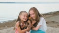 Two children playing which dogs on the sand on the beach. Royalty Free Stock Photo