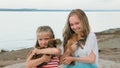 Two children playing which dogs on the sand on the beach. Royalty Free Stock Photo