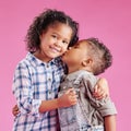 Two children only posing and being affectionate against a pink copyspace background. African American mixed race Royalty Free Stock Photo