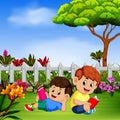 Two children reading book in the yard Royalty Free Stock Photo