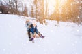 Two children ride on wooden retro sled on sunny winter day. Active winter outdoors games. Winter activities for kids Royalty Free Stock Photo