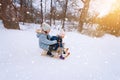 Two children ride on wooden retro sled on sunny winter day. Active winter outdoors games. Winter activities for kids Royalty Free Stock Photo