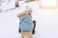 Two children ride on wooden retro sled on sunny winter day. Active winter outdoors games. Winter activities for kids Royalty Free Stock Photo