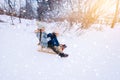 Two children ride on wooden retro sled on sunny winter day. Active winter outdoors games. Winter activities for kids Royalty Free Stock Photo