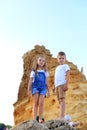 Two children are on the rocks by the sea Royalty Free Stock Photo