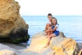 Two children are on the rocks by the sea Royalty Free Stock Photo