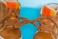 Two children`s Shoe on a blue background, tied knot Royalty Free Stock Photo