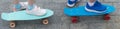 Two children`s skateboards, close-ups, with standing feet on them