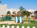 Two children slides and swings on the playground in summer Royalty Free Stock Photo