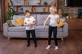 Two children sing song in karaoke and dance. Concept is childhood, vocal, music, singing, friendship Royalty Free Stock Photo