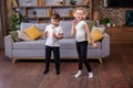 Two children sing song in karaoke and dance. Concept is childhood, vocal, music, singing, friendship Royalty Free Stock Photo