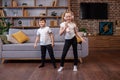 Two children sing song in karaoke and dance. Concept is childhood, vocal, music, singing, friendship Royalty Free Stock Photo