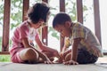 Two children sit and watch the smartphone happily. young boys and girls with cellphone communication. on the terrace of their