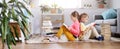 Two children sitting on the floor in the room and reading books Royalty Free Stock Photo