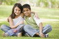 Two children sitting in park