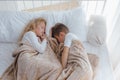 Two children sleep in their crib, boy and little girl sleep in bed Royalty Free Stock Photo