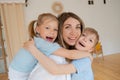 Two children son and daughter hug their mother. Happy loving family standing Royalty Free Stock Photo