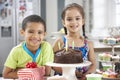 Two Children Standing By Table Laid With Birthday Party Food Royalty Free Stock Photo