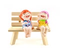 Two children statue to happy and smile , sitting on the wooden c Royalty Free Stock Photo