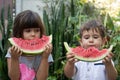 Two children summer portrait. Smiling children outdoor. Happy smiling child eating watermelon in park. Royalty Free Stock Photo