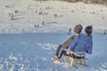 Two children on a toboggan start down the hill in Poland