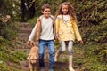 Two Children Walking Down Steps In Countryside With Pet Dog On Winter Beach Vacation Royalty Free Stock Photo