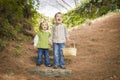 Two Children Walking Down Wood Steps with Basket Outside.