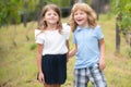 Two children walking outdoors. Portrait of adorable brother and sister smile and laugh together. Happy lifestyle kids. Royalty Free Stock Photo