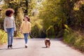 Two Children Walking Pet French Bulldog Dog Along Country Road Royalty Free Stock Photo