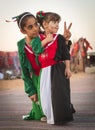 Two children wear national UAE dress
