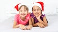Two Children wearing Santa hats smiling on isolated white background Royalty Free Stock Photo