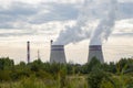 Two chimneys of the power plant smoke in the distance Royalty Free Stock Photo