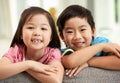 Two Chinese Children Relaxing On Sofa At Home Royalty Free Stock Photo