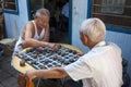 Two Chinese man playing Chinese Chess Xiangqi in a street of the city of Dunhuang, China Royalty Free Stock Photo