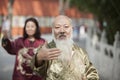 Two Chinese People Practicing Tai Ji in Traditional Costume