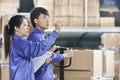 Two chinese workers in warehouse