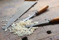 Two chisels and a saw in the Workbench with a wooden vise Royalty Free Stock Photo