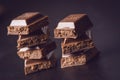 Two chocolate buildings on a dark background. energy and sugar. Broken bar. Chocolate blocks stack