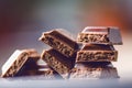 Two chocolate buildings on a dark background. energy and sugar. Broken bar. Chocolate blocks stack