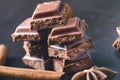 Two chocolate buildings on a dark background. energy and sugar. Broken bar. Chocolate blocks stack