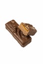 Two chocolate candy bars are displayed, featuring a gooey caramel center and a soft nougat layer, set against a pri Royalty Free Stock Photo