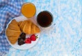 Two chocolate croissants strawberries, a cup of coffee and a glass of orange juice. Breakfast concept. Top view. Copy space. Royalty Free Stock Photo