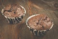 two chocolate muffins/two chocolate muffins on a dark wooden table. Selective focus Royalty Free Stock Photo